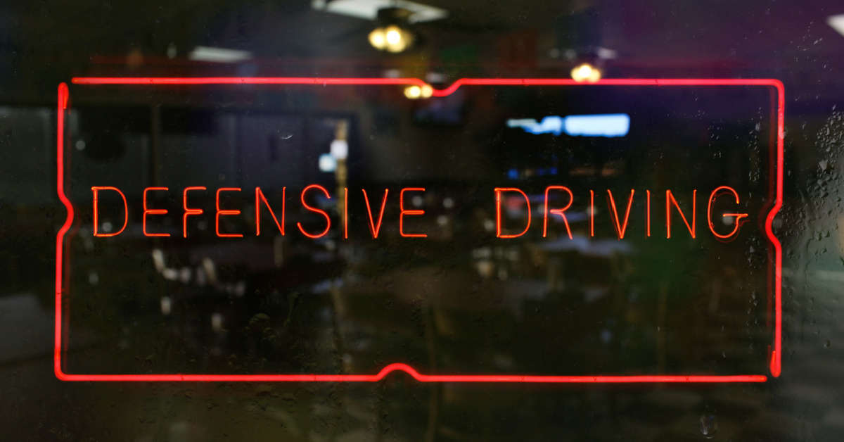 The words defensive driving are the focus of the image.